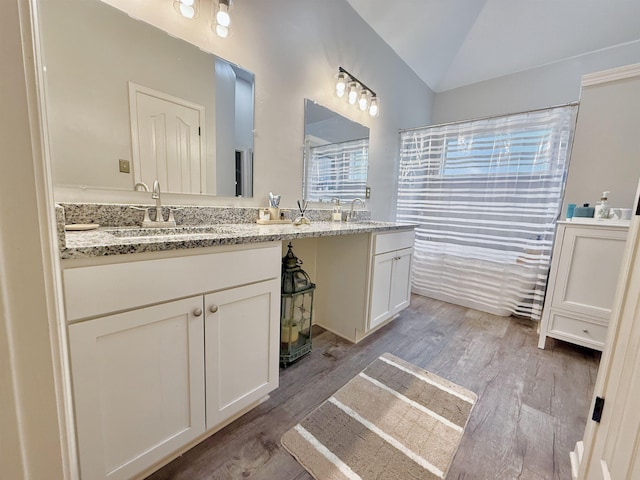 1210 Sanbyrn Dr, Cordova, TN 38018 - bathroom with wood finished floors, double vanity, and vaulted ceiling