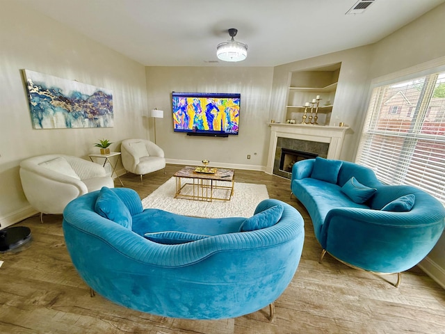 1210 Sanbyrn Dr, Cordova, TN 38018 - living room featuring baseboards, a tiled fireplace, and wood finished floors