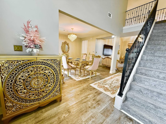 1210 Sanbyrn Dr, Cordova, TN 38018 - stairway featuring wood finished floors, a chandelier, and baseboards