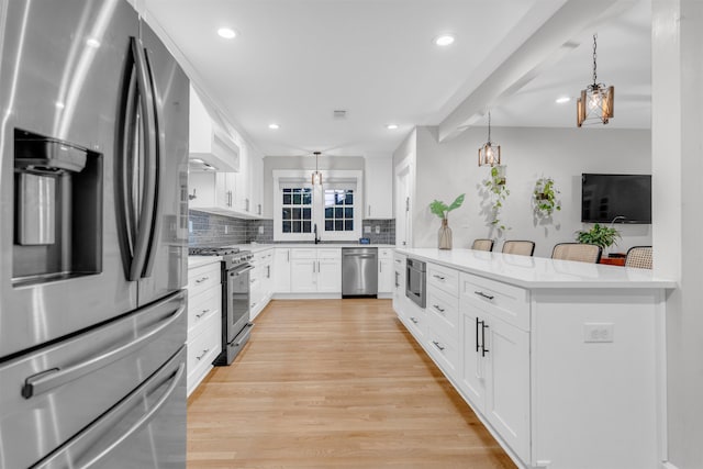 185 Alexander St, Memphis, TN 38111 - kitchen with appliances with stainless steel finishes, backsplash, pendant lighting, light wood-type flooring, and recessed lighting