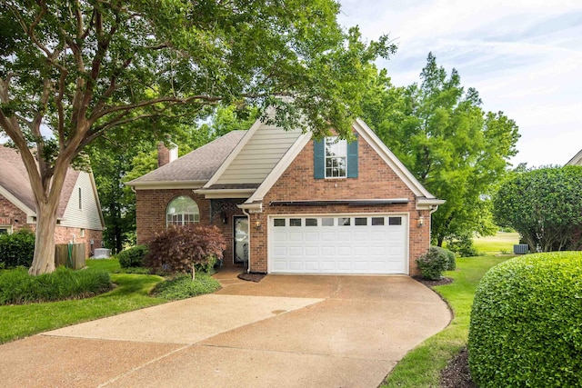 6232 Lake View Cv, Bartlett, TN 38135 - view of front facade with driveway, brick siding, an attached garage, a front yard, and a chimney