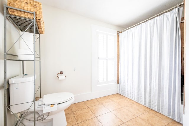 bathroom with toilet and tile patterned floors