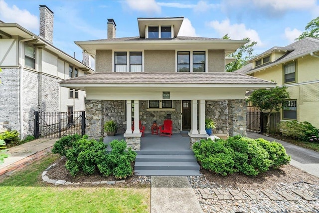 1751 Carr Ave, Memphis, TN 38104 - american foursquare style home with a porch, stucco siding, stone siding, fence, and a gate