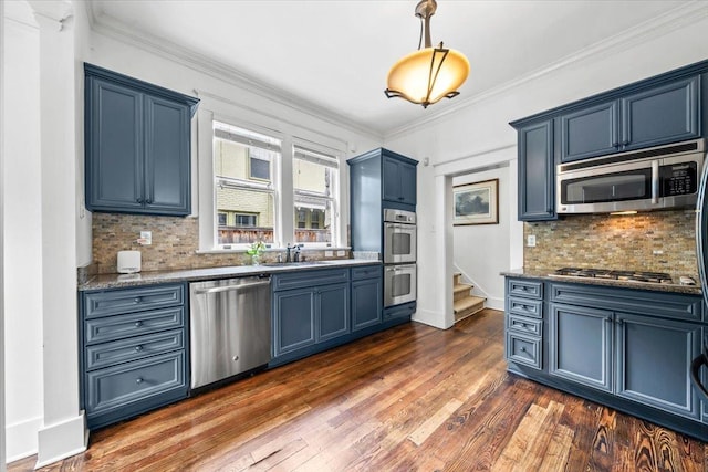 1751 Carr Ave, Memphis, TN 38104 - kitchen featuring stainless steel appliances, blue cabinets, backsplash, dark wood-style flooring, and crown molding