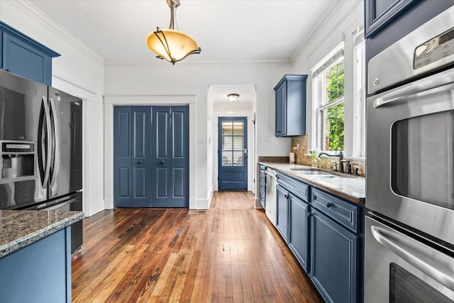 1751 Carr Ave, Memphis, TN 38104 - kitchen with blue cabinets, stainless steel appliances, a sink, dark wood-type flooring, and crown molding