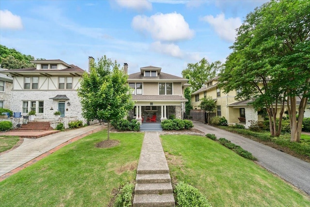 1751 Carr Ave, Memphis, TN 38104 - traditional style home with a porch, a front lawn, and a chimney