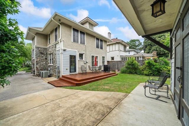 1751 Carr Ave, Memphis, TN 38104 - rear view of house with a patio area, a wooden deck, cooling unit, and stone siding