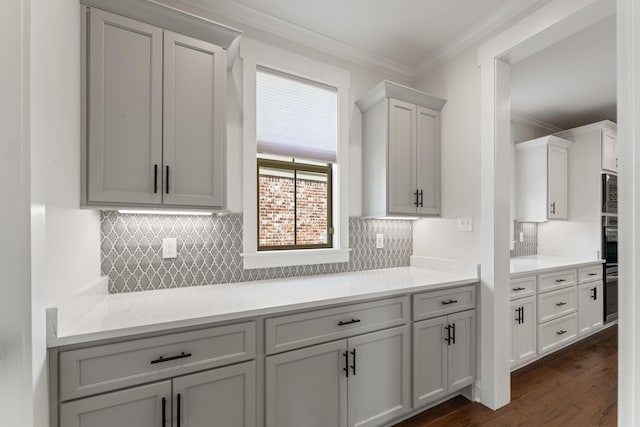 940 Cypress Vine Cv, Collierville, TN 38017 - kitchen featuring crown molding, light countertops, decorative backsplash, dark wood-style floors, and double oven