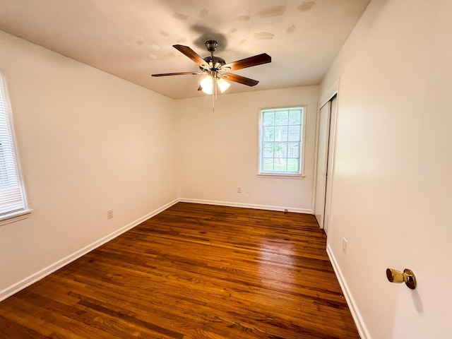 4486 Mayo Ave, Memphis, TN 38128 - spare room with dark wood finished floors, a ceiling fan, and baseboards
