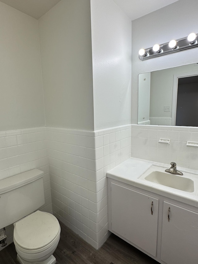 4486 Mayo Ave, Memphis, TN 38128 - half bathroom featuring tile walls, toilet, wood finished floors, a wainscoted wall, and vanity