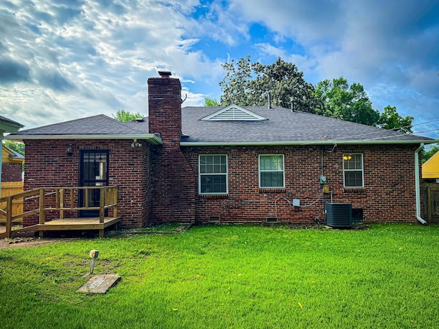 4486 Mayo Ave, Memphis, TN 38128 - rear view of house with a chimney, roof with shingles, a lawn, a wooden deck, and brick siding