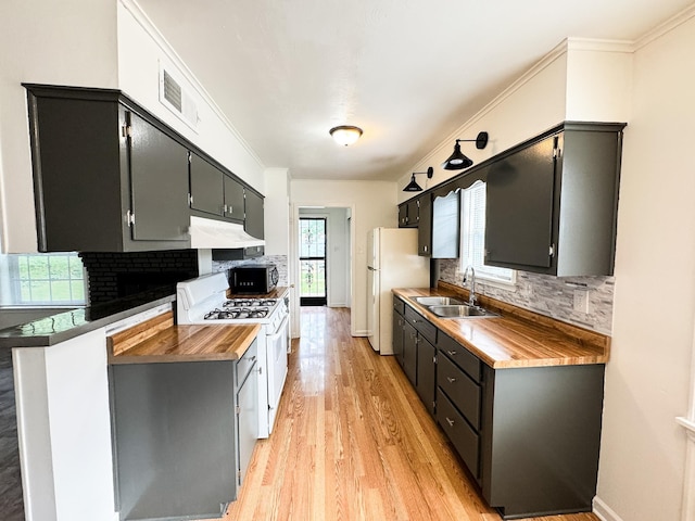 4486 Mayo Ave, Memphis, TN 38128 - kitchen featuring a sink, white appliances, decorative backsplash, light wood-type flooring, and ornamental molding
