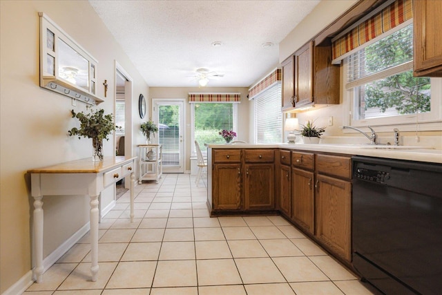 8570 W Park Trail Dr, Germantown, TN 38139 - kitchen featuring dishwasher, a ceiling fan, brown cabinets, plenty of natural light, and a textured ceiling