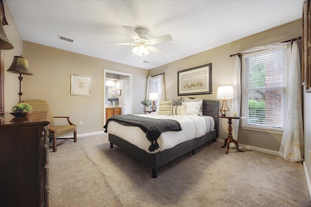 8570 W Park Trail Dr, Germantown, TN 38139 - bedroom featuring baseboards, light colored carpet, ensuite bathroom, and a textured ceiling