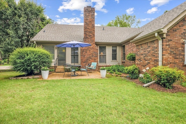 8570 W Park Trail Dr, Germantown, TN 38139 - rear view of house featuring a chimney, a yard, a patio, and a shingled roof