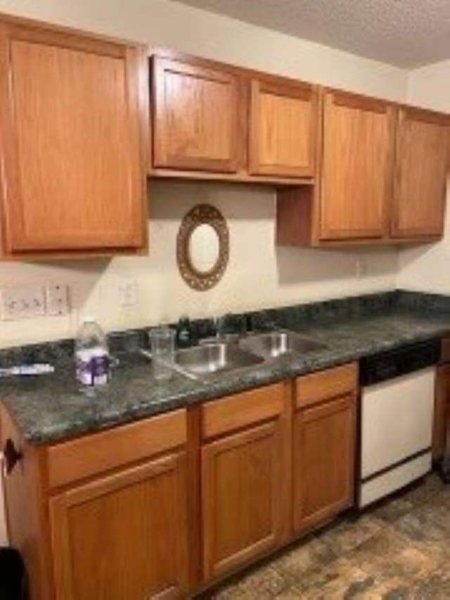 2583 Faxon Ave, Memphis, TN 38112 - kitchen with dishwasher, a textured ceiling, dark countertops, and brown cabinets