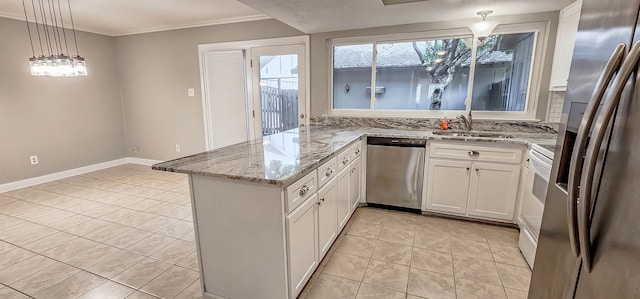 1731 Hobbits Glen Dr Unit 14, Germantown, TN 38138 - kitchen featuring appliances with stainless steel finishes, a sink, a peninsula, white cabinets, and light stone counters