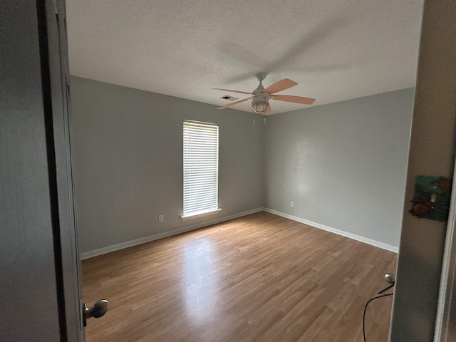 6823 Northknoll Ave, Millington, TN 38053 - unfurnished room featuring ceiling fan, wood finished floors, baseboards, and a textured ceiling