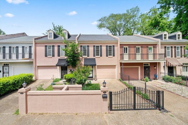 2268 Tunis Cv Unit 2268, Memphis, TN 38104 - view of property with stucco siding, a garage, a fenced front yard, and driveway