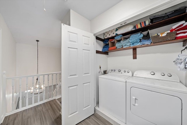2268 Tunis Cv Unit 2268, Memphis, TN 38104 - laundry area featuring washer and clothes dryer, wood finished floors, and a chandelier