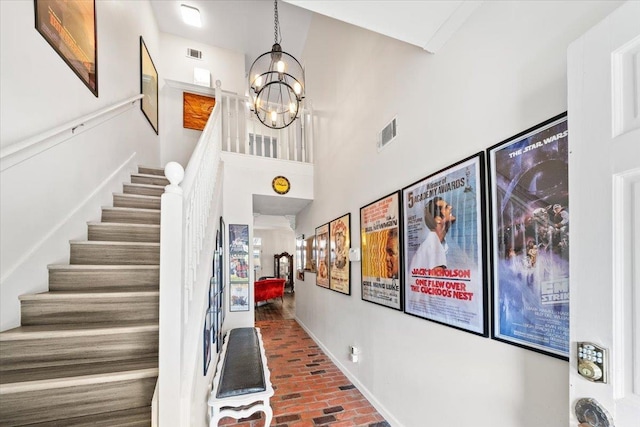 2268 Tunis Cv Unit 2268, Memphis, TN 38104 - entrance foyer featuring brick floors, stairway, and a chandelier