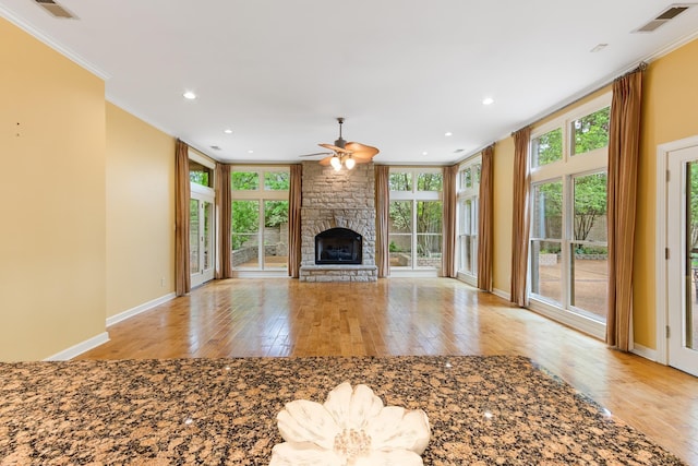 7475 Willey Rd, Germantown, TN 38138 - unfurnished living room with crown molding, light wood-style floors, a ceiling fan, a stone fireplace, and baseboards