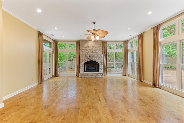 7475 Willey Rd, Germantown, TN 38138 - unfurnished living room with ornamental molding, light wood-type flooring, a ceiling fan, plenty of natural light, and a stone fireplace