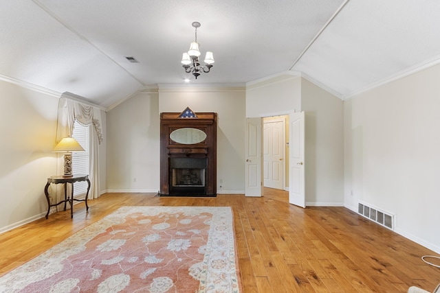 7475 Willey Rd, Germantown, TN 38138 - living room featuring lofted ceiling, ornamental molding, wood finished floors, a chandelier, and baseboards