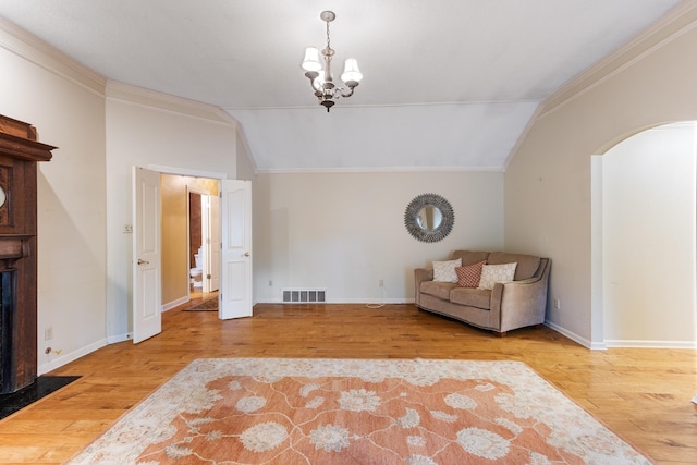 7475 Willey Rd, Germantown, TN 38138 - sitting room featuring lofted ceiling, wood finished floors, crown molding, a chandelier, and arched walkways