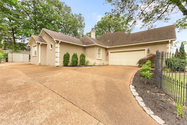 7475 Willey Rd, Germantown, TN 38138 - view of front facade featuring driveway, fence, stucco siding, a chimney, and a garage