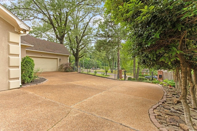 7475 Willey Rd, Germantown, TN 38138 - view of patio featuring fence, driveway, and a garage