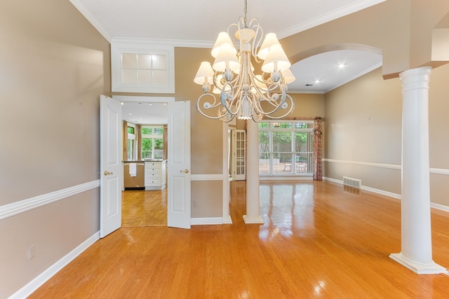 7475 Willey Rd, Germantown, TN 38138 - unfurnished dining area with healthy amount of natural light, light wood-type flooring, baseboards, arched walkways, and ornamental molding