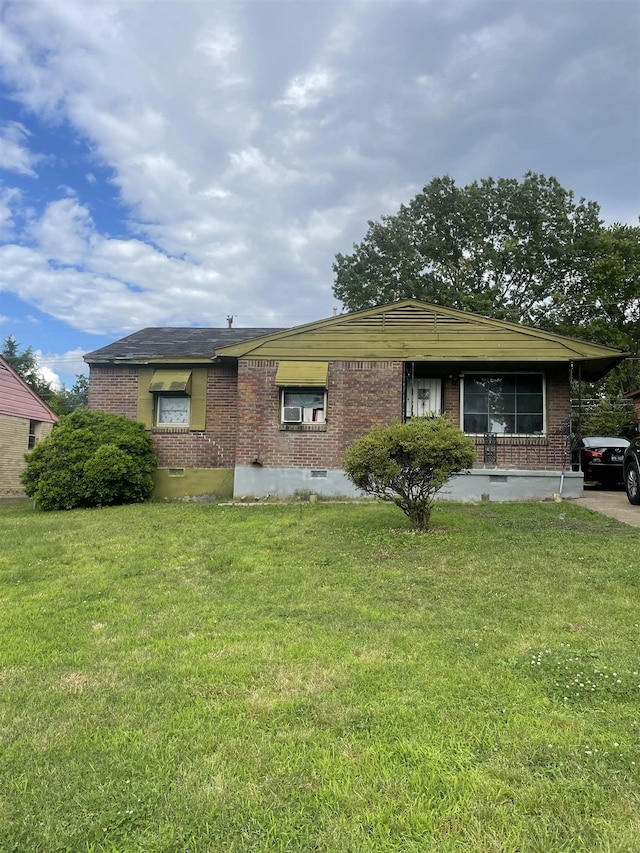 3568 W Horn Lake Rd, Memphis, TN 38109 - view of front facade with brick siding, a front lawn, and crawl space