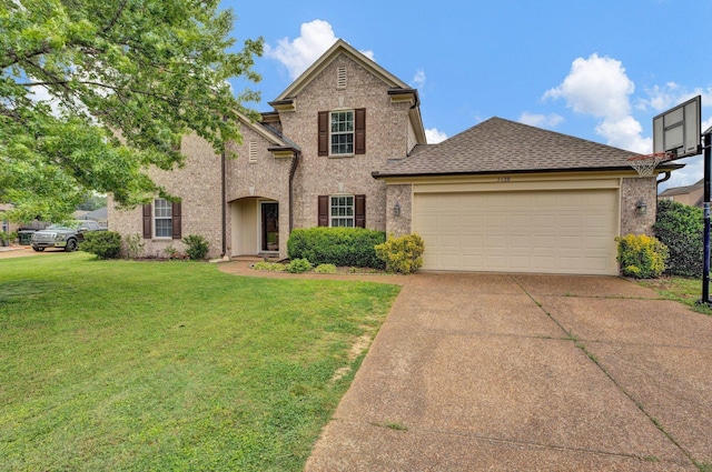 5128 N Fluss Cv, Bartlett, TN 38135 - traditional-style home featuring a front yard, concrete driveway, an attached garage, brick siding, and a shingled roof