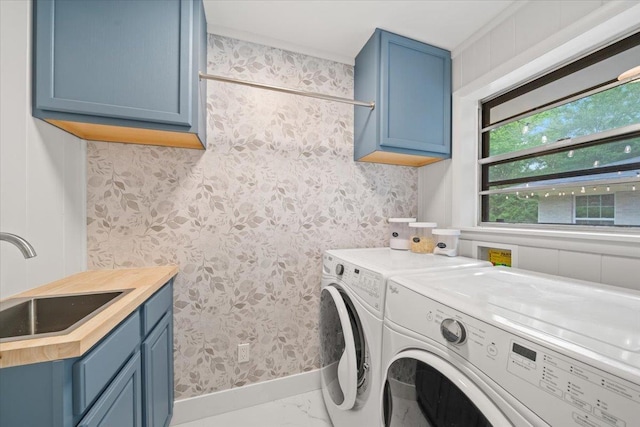 4539 Kings Park Rd, Memphis, TN 38117 - washroom featuring washing machine and clothes dryer, cabinet space, and wallpapered walls