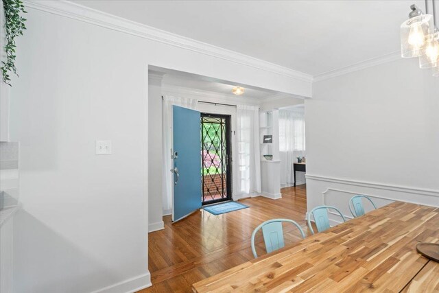 4539 Kings Park Rd, Memphis, TN 38117 - unfurnished dining area with wood finished floors, crown molding, and baseboards