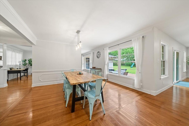 4539 Kings Park Rd, Memphis, TN 38117 - dining space with crown molding, wood finished floors, healthy amount of natural light, a chandelier, and baseboards