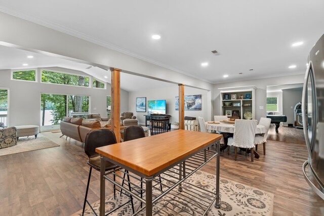 975 Buchanan Peninsula St, Cherokee, AL 35616 - dining area with wood finished floors, ornate columns, vaulted ceiling, recessed lighting, and plenty of natural light