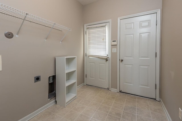 washroom with hookup for an electric dryer and baseboards