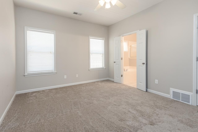 spare room featuring ceiling fan, carpet flooring, and baseboards