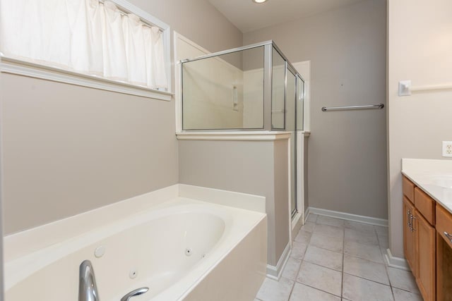 full bath with a stall shower, tile patterned floors, vanity, a tub with jets, and baseboards