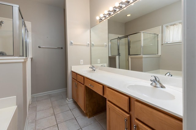 full bathroom with a stall shower, tile patterned floors, double vanity, and baseboards