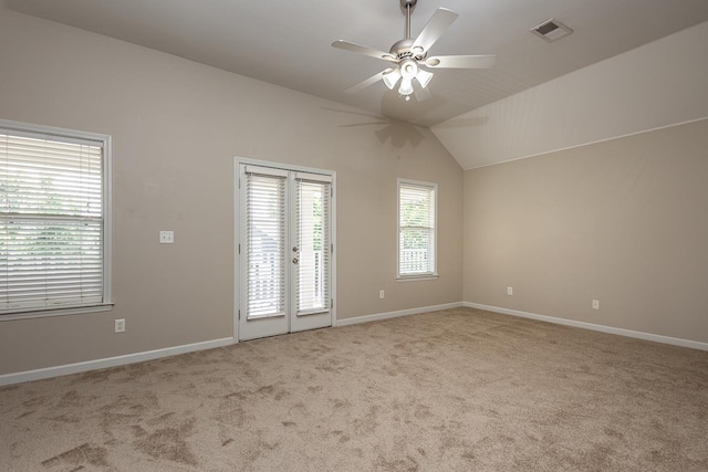carpeted empty room featuring ceiling fan, baseboards, french doors, and lofted ceiling