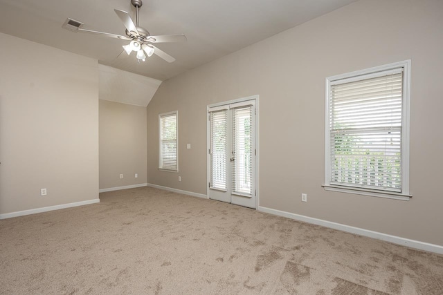 spare room with carpet, ceiling fan, baseboards, and lofted ceiling