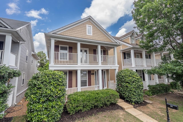 view of front facade featuring covered porch and a balcony