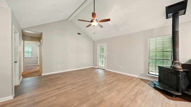 979 Ray Bluff Rd, Millington, TN 38053 - unfurnished living room with a wood stove, ceiling fan, light wood finished floors, beam ceiling, and baseboards
