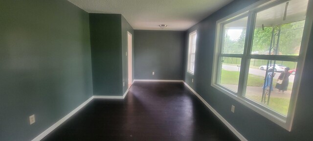 1535 Oberle Rd, Memphis, TN 38127 - empty room featuring baseboards, plenty of natural light, wood finished floors, and a textured ceiling