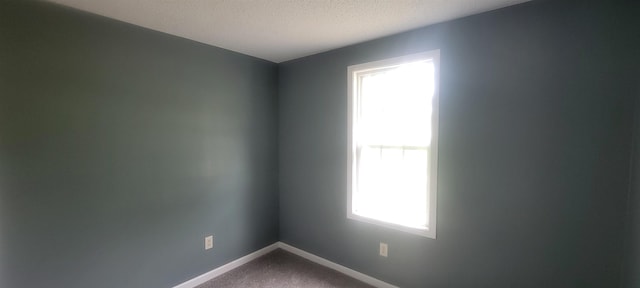 1535 Oberle Rd, Memphis, TN 38127 - unfurnished room with dark carpet, baseboards, and a textured ceiling
