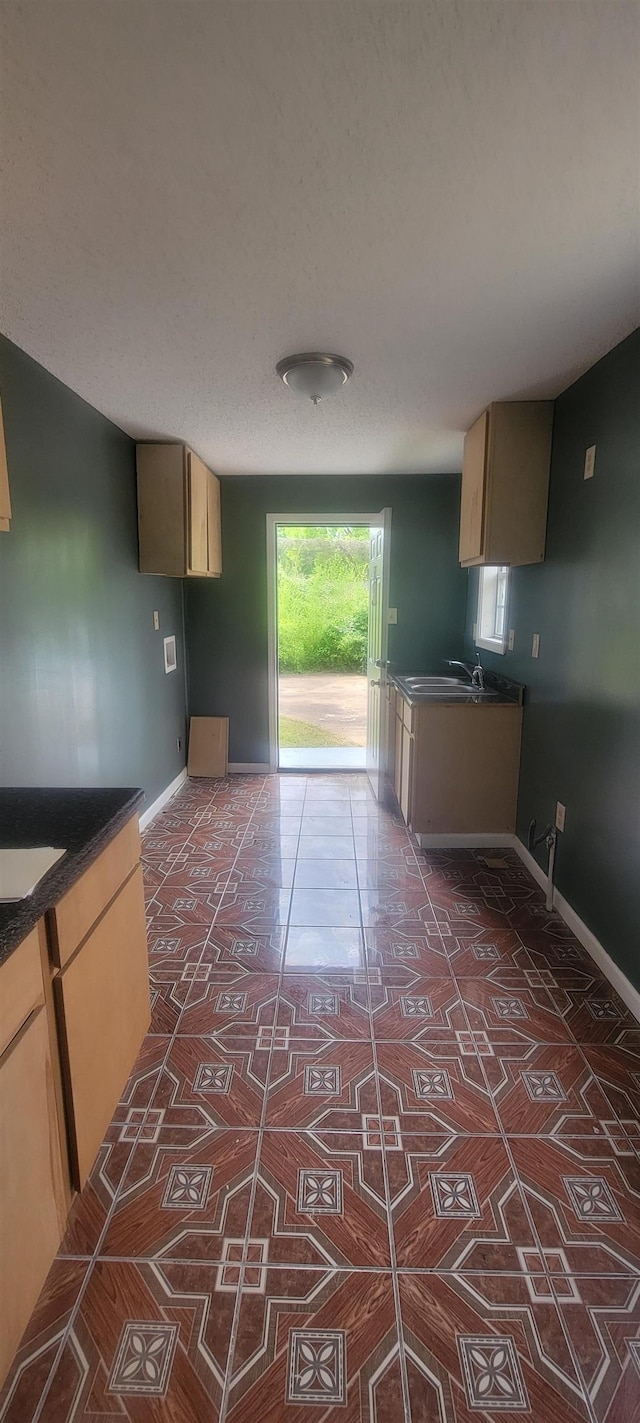 1535 Oberle Rd, Memphis, TN 38127 - kitchen with baseboards, dark countertops, and dark tile patterned flooring