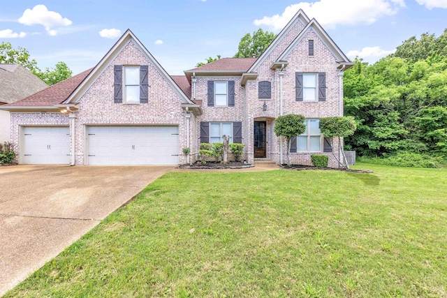 1235 Gimel Ln, Cordova, TN 38016 - view of front of house with concrete driveway, a front lawn, brick siding, and a garage